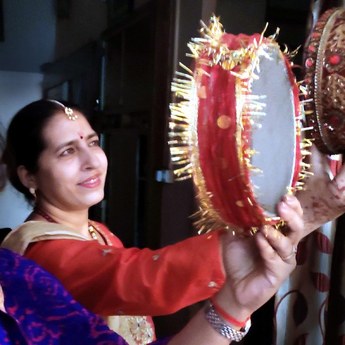 After a day long fasting of Karva Chauth, suhagins (married women) viewing the moon through the sieve. Towards the wishes of long and healthy life of their beloved husband, women used to keep the entire day fast and prays as per their traditions. By the end of the day the fasting women conclude the ritual while having the first view of fresh moon. This ritual is a part of their annual tradition among hindu married women.